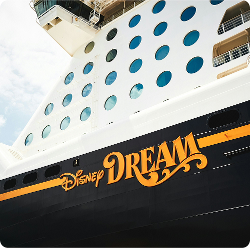 The Disney Dream name appears below rows of circular portholes on the ship's hull
