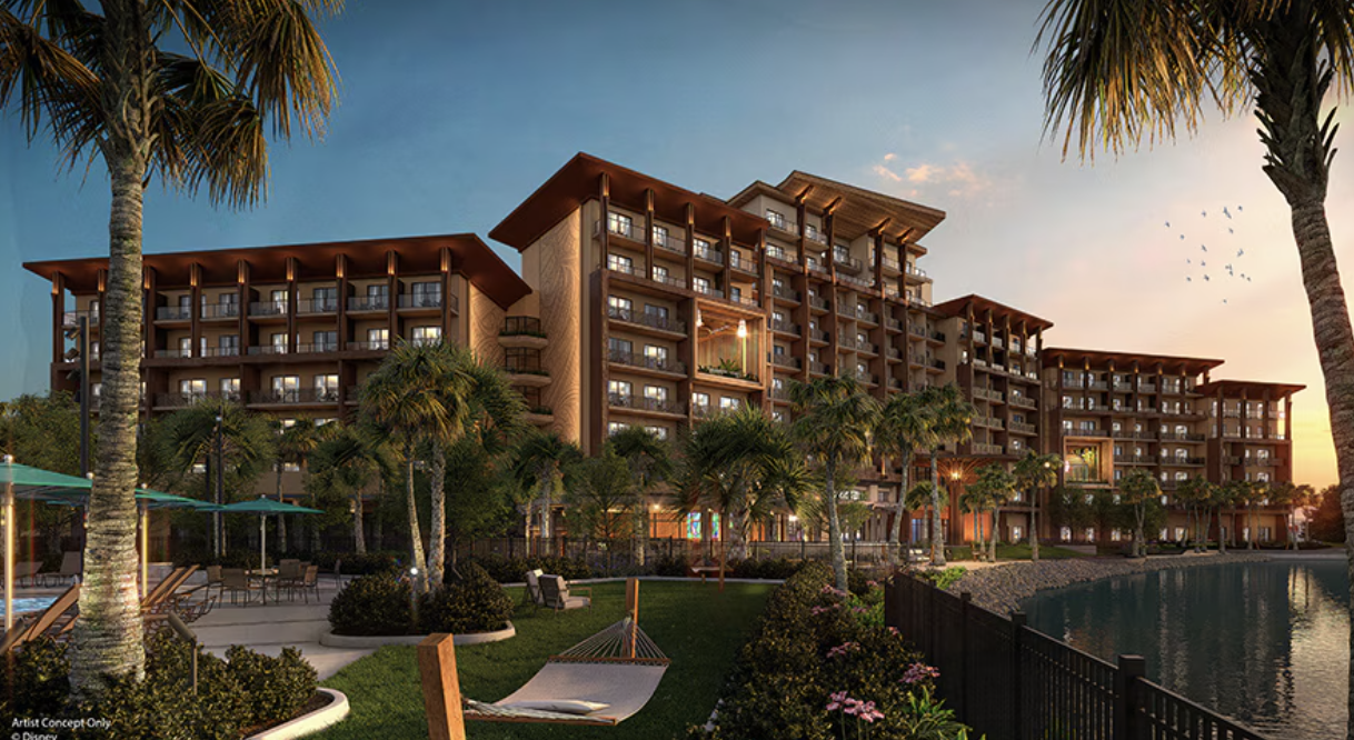 Island Tower rises above palm trees and waterfront landscaping at sunset